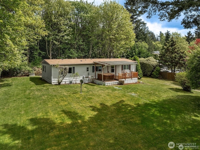 back of house with a yard, a deck, and fence