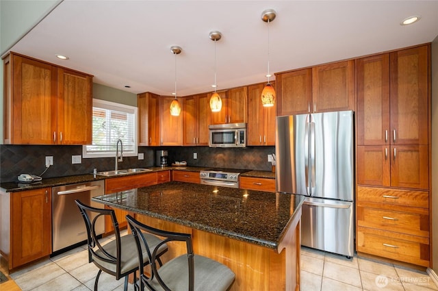 kitchen with a sink, brown cabinets, and appliances with stainless steel finishes