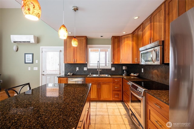 kitchen featuring brown cabinets, an AC wall unit, stainless steel appliances, and a sink