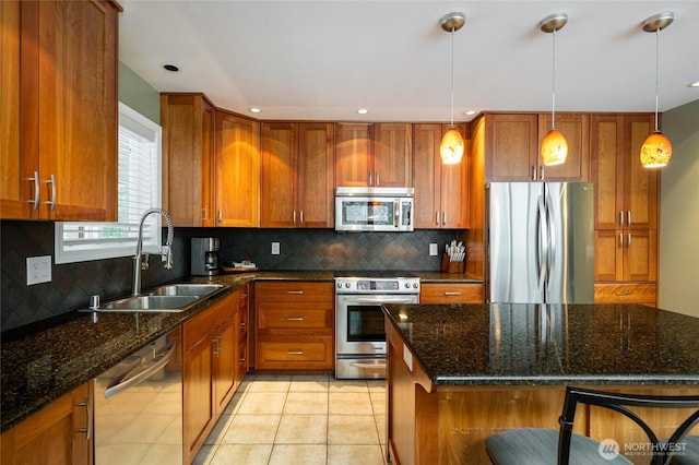 kitchen featuring a sink, brown cabinetry, tasteful backsplash, and stainless steel appliances