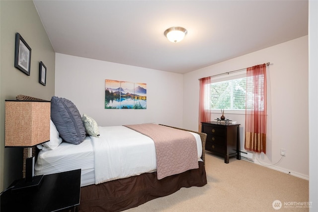 carpeted bedroom featuring baseboards and a baseboard radiator