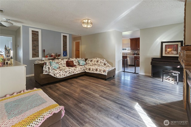 living area featuring baseboards, a textured ceiling, and dark wood-style flooring