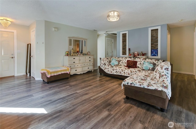 living room with wood finished floors, baseboards, and a textured ceiling