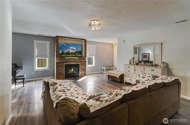 living area featuring a fireplace, wood finished floors, and visible vents