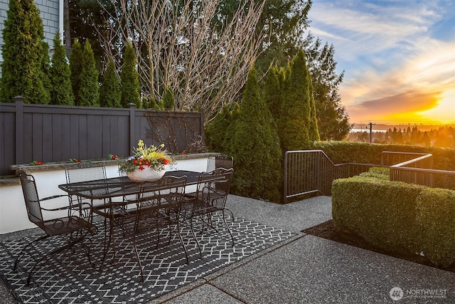 view of patio with outdoor dining space and fence