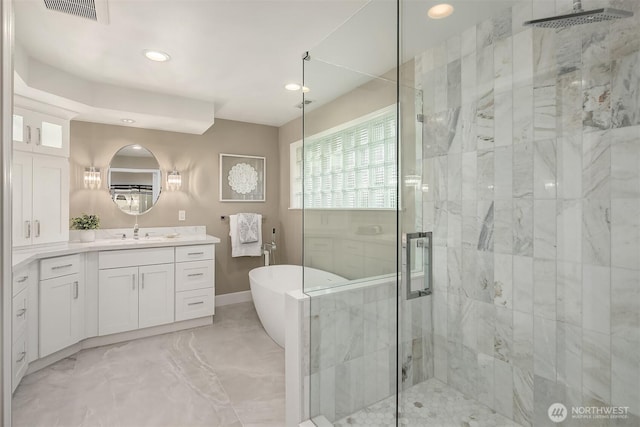 bathroom featuring visible vents, marble finish floor, a shower stall, a soaking tub, and vanity