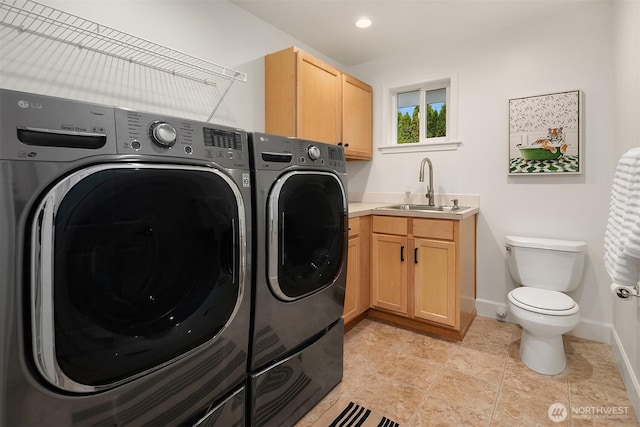 laundry area featuring a sink, baseboards, laundry area, recessed lighting, and separate washer and dryer