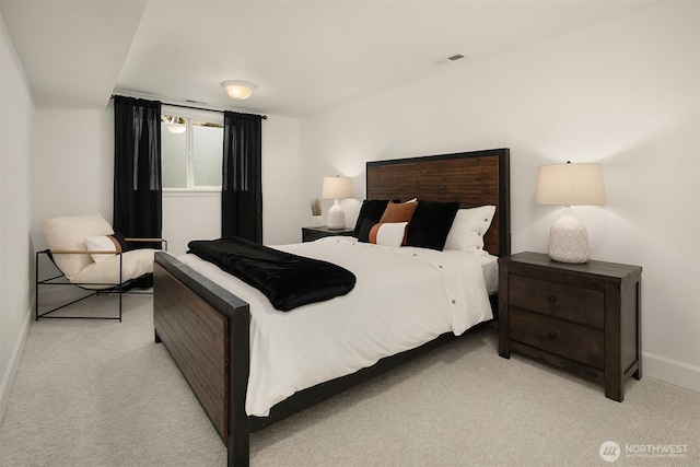 bedroom with baseboards, visible vents, and light carpet