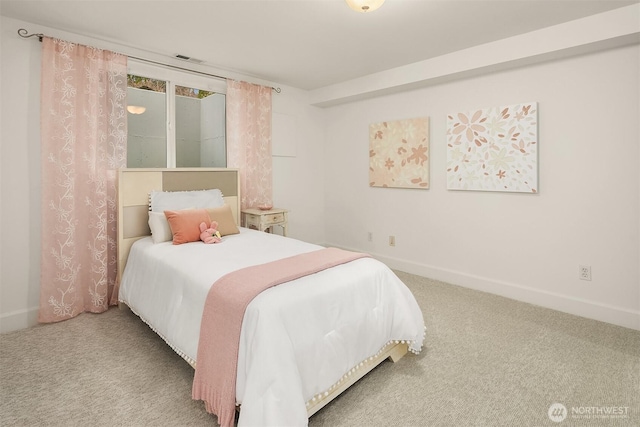 carpeted bedroom with visible vents and baseboards