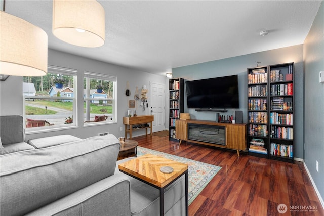 living area featuring wood finished floors and baseboards