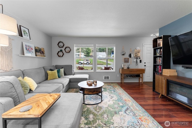 living room with dark wood finished floors and visible vents