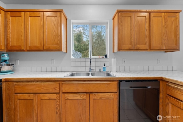 kitchen with a sink, brown cabinets, tile countertops, and tile patterned floors