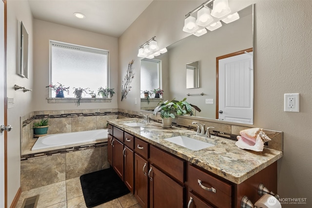 bathroom featuring visible vents, double vanity, a sink, tile patterned flooring, and a bath