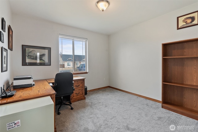 carpeted home office with baseboards