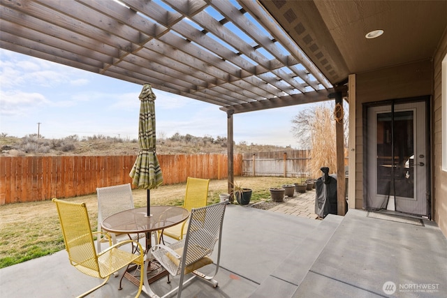 view of patio featuring a fenced backyard, outdoor dining space, and a pergola