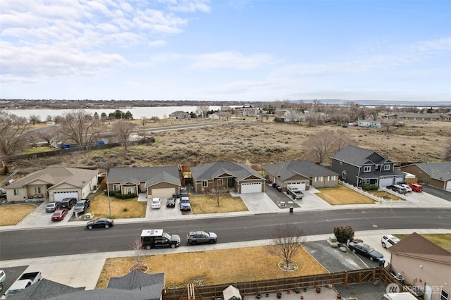 birds eye view of property featuring a residential view and a water view