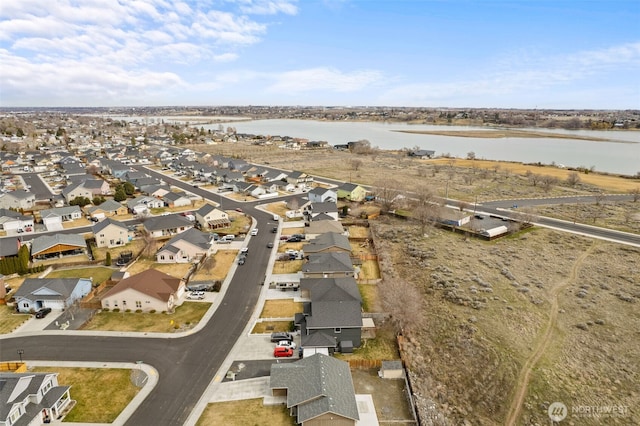 drone / aerial view with a residential view and a water view