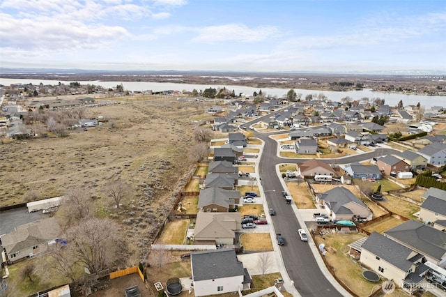 birds eye view of property with a residential view and a water view