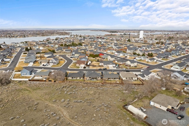 birds eye view of property featuring a residential view and a water view