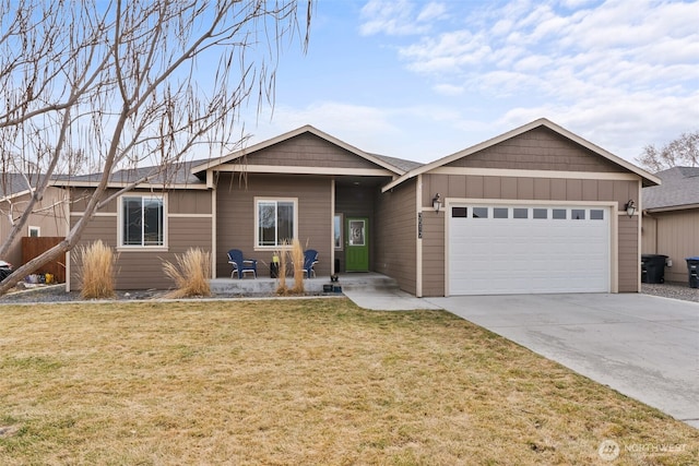 ranch-style home with a garage, a front yard, and driveway