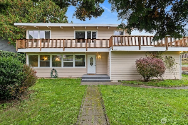 view of front facade featuring a deck and a front lawn