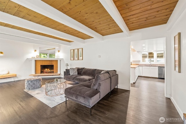 living area with beam ceiling, wood ceiling, baseboards, and dark wood-style flooring