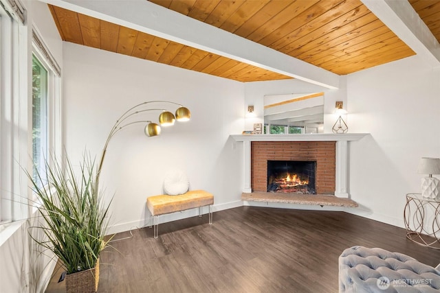 sitting room featuring baseboards, beam ceiling, wood ceiling, and wood finished floors