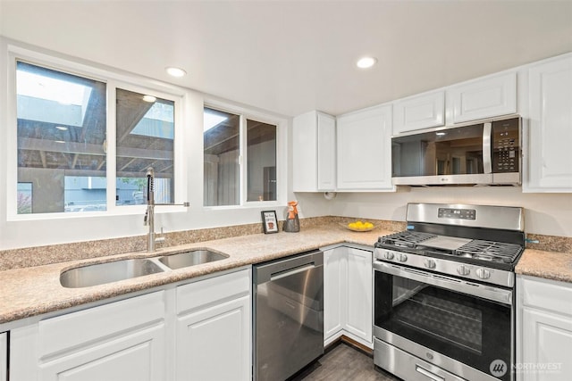 kitchen with white cabinets, recessed lighting, appliances with stainless steel finishes, and a sink