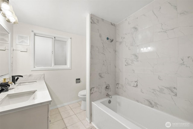 bathroom featuring a sink, baseboards, toilet, and double vanity