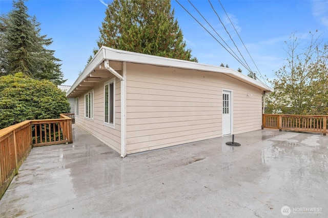 view of side of property with a patio area