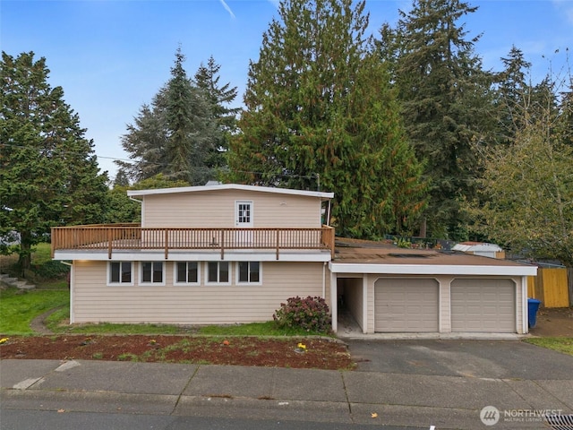 traditional home with aphalt driveway and an attached garage