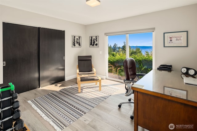 home office featuring baseboards and light wood-type flooring