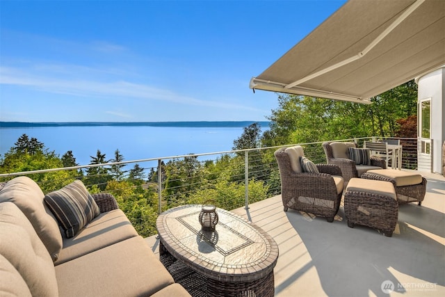 view of patio featuring a water view, a balcony, and an outdoor hangout area