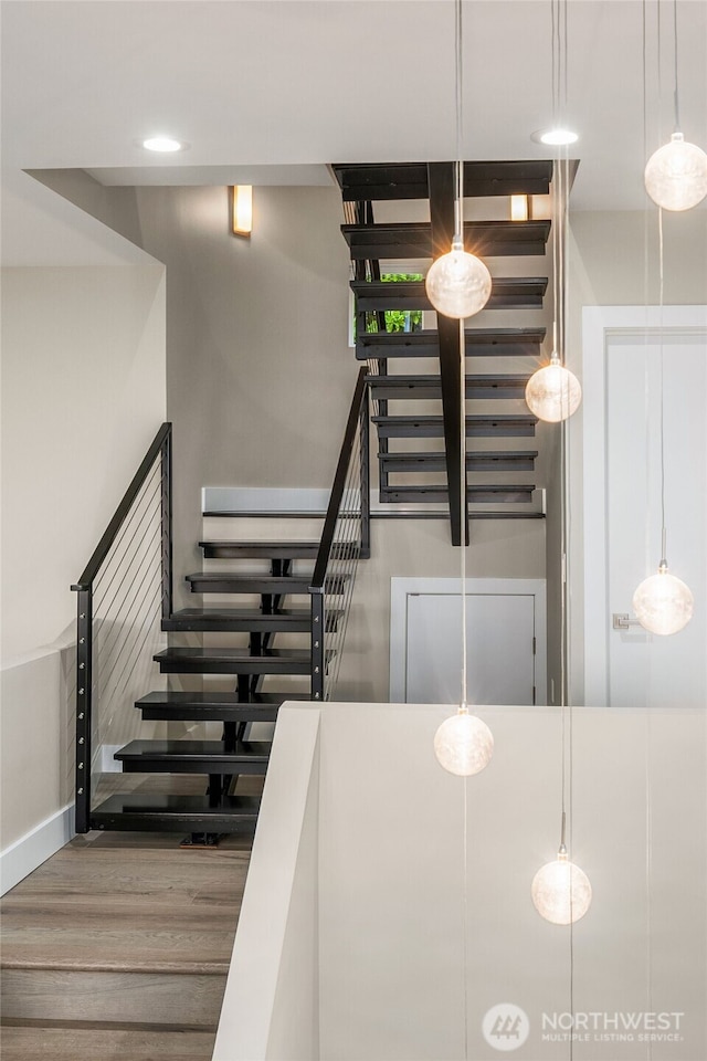 stairs featuring baseboards and wood finished floors