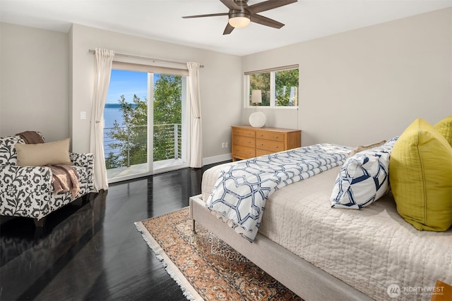 bedroom featuring access to exterior, a ceiling fan, baseboards, and wood finished floors