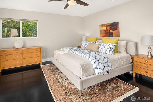 bedroom with wood finished floors, baseboards, and ceiling fan