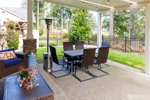 view of patio featuring outdoor dining area and fence