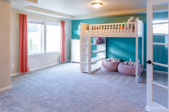 carpeted bedroom featuring french doors and baseboards