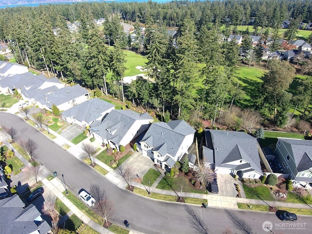 drone / aerial view with a residential view and a view of trees