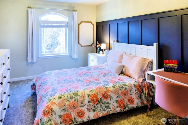 carpeted bedroom with a decorative wall