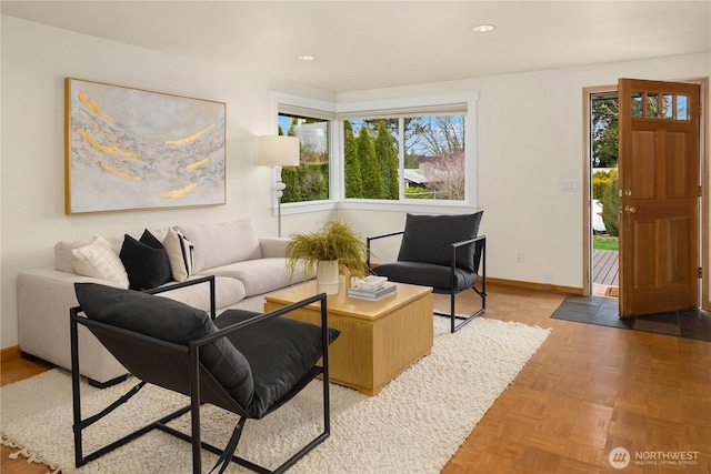 living area featuring recessed lighting and baseboards