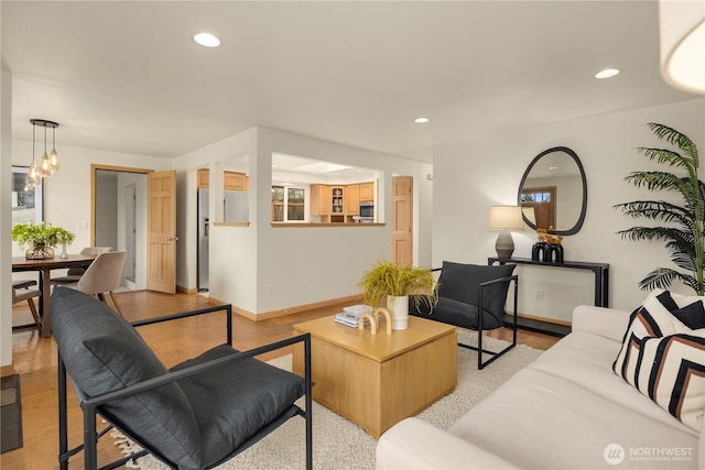 living room with recessed lighting and light wood-type flooring