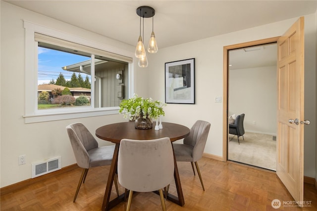 dining space with baseboards and visible vents