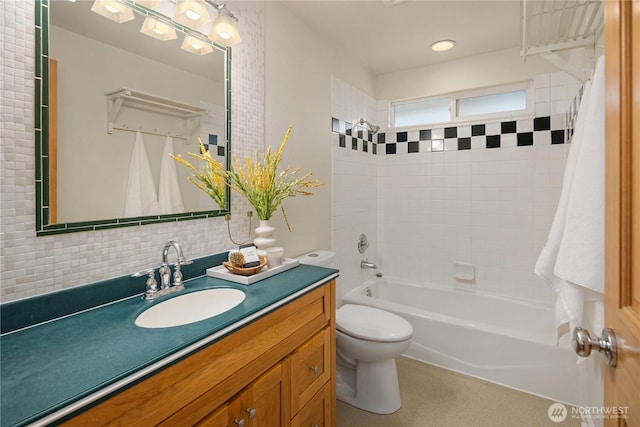 bathroom with backsplash, vanity, toilet, and shower / tub combo