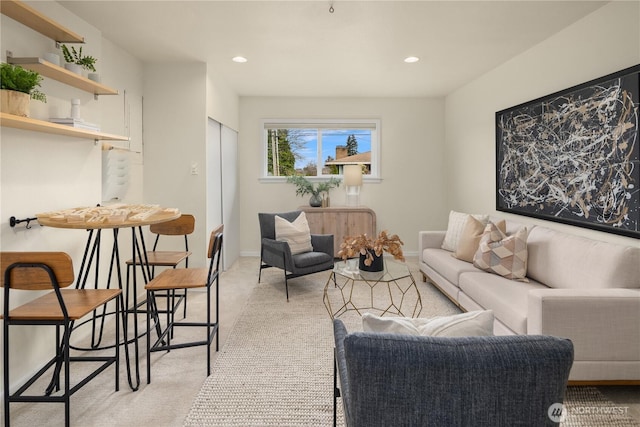 living area with recessed lighting, baseboards, and light colored carpet