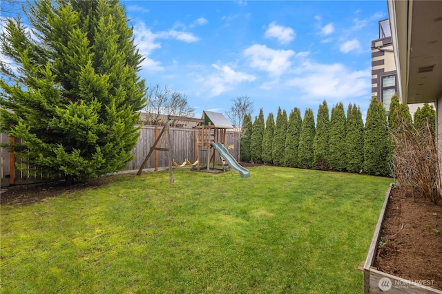 view of yard featuring a fenced backyard and a playground