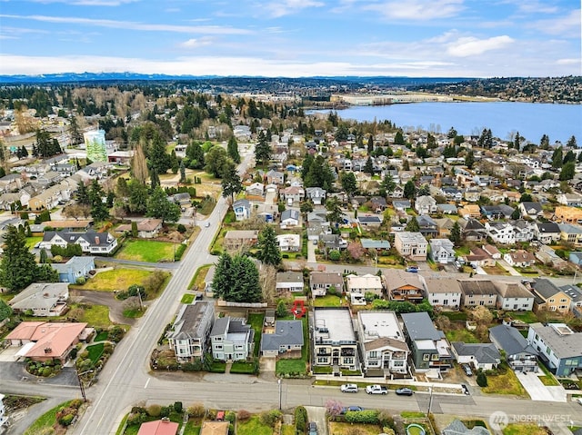 drone / aerial view featuring a residential view and a water view