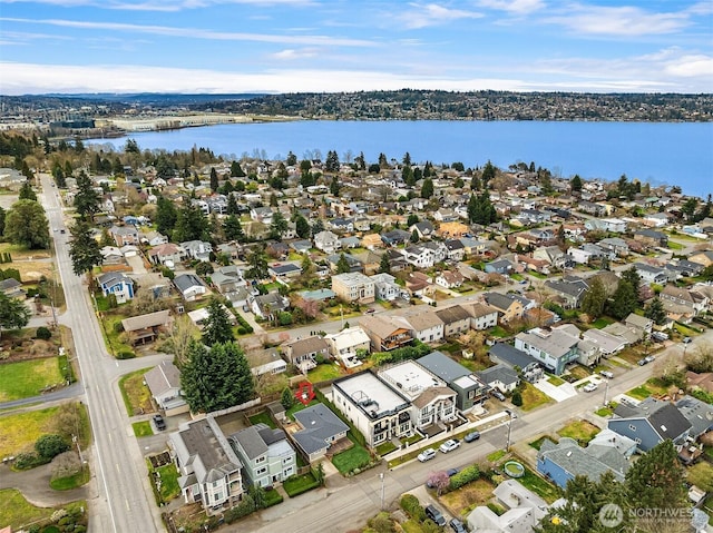 birds eye view of property with a water view and a residential view