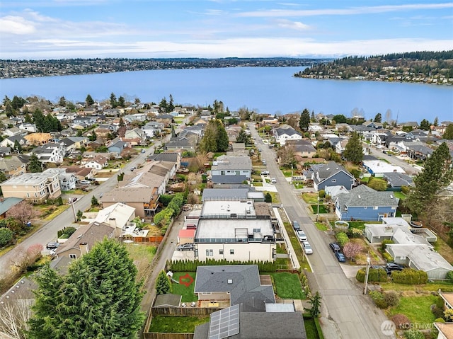 birds eye view of property with a water view and a residential view