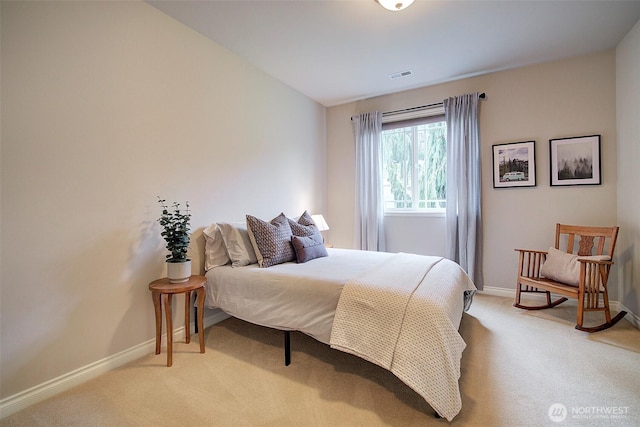 bedroom with visible vents, light colored carpet, and baseboards